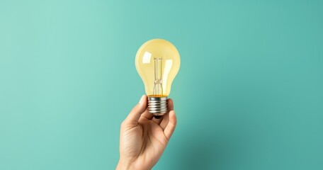 Hand holding light bulb on green background, concept of ideas and creativity. Generative AI - obrazy, fototapety, plakaty