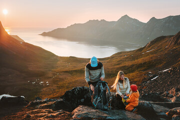 Family hiking in Norway mountains travel adventure vacations group hikers mother and father with child backpacking outdoor healthy lifestyle eco tourism