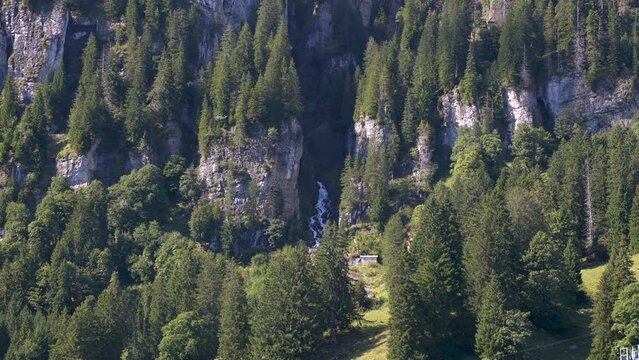 Waterfall in the mountains. Water falls from the rocks high in the mountains. Brummbachfall, Linthal, Braunwald, canton of Glarus in Switzerland