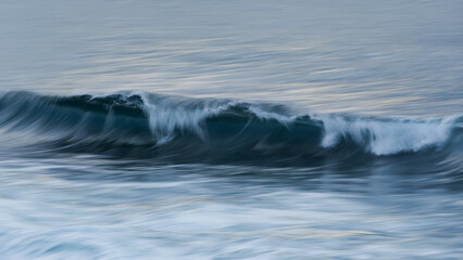 Powerful breaking wave in motion in the ocean.