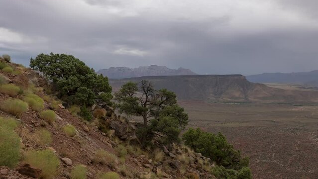 4K time lapse video of a summer monsoon rainstorm as it moves over the distant mountains of Zion Nat. Park Utah with the slope of Smith Mesa in the foreground.