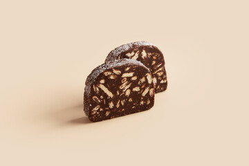 Traditional portuguese dessert Salame de Chocolate on beige background in minimal style. Restaurant bakery menu