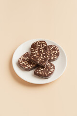 Traditional portuguese dessert Salame de Chocolate on beige background in minimal style. Restaurant bakery menu