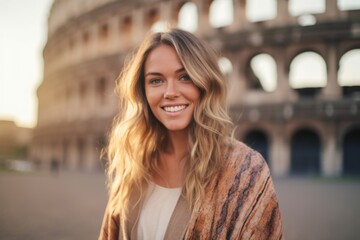 Headshot portrait photography of a pleased woman in her 30s that is wearing a chic cardigan against the Colosseum in Rome Italy