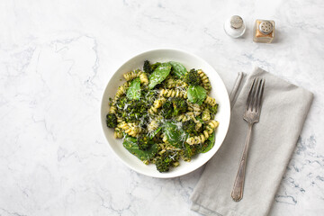 Bowl of Broccoli Pesto Pasta on a White Background