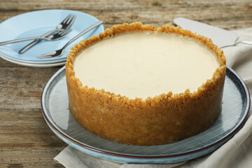 Tasty vegan tofu cheesecake on wooden table
