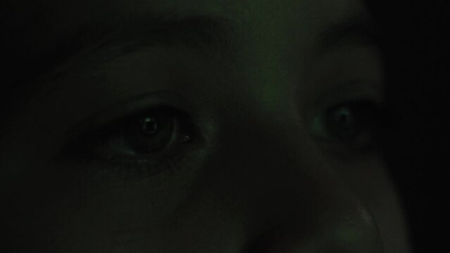 Eye of a child looking at a screen close up - technology addiction concept