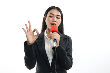 Portrait of beautiful young woman wearing black suit talking into microphone isolated on white background.