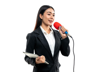 Beautiful Asian female reporter holding tablet while speaking into microphone isolated on white...