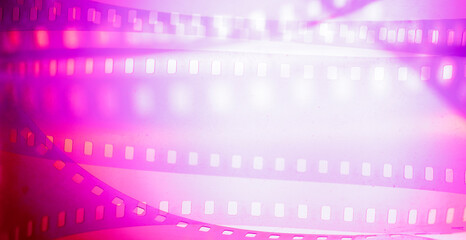 pink magenta color background with film strip. cinematography premiere film production show...