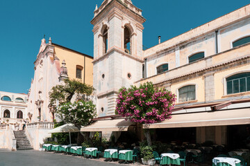 San Giuseppe Church and al fresco cafe with outdoor seating on a sunny summer day