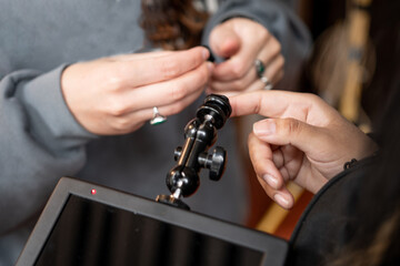 Hands working with tripod 