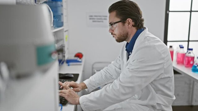Young hispanic man scientist using computer taking glasses off stressed at laboratory