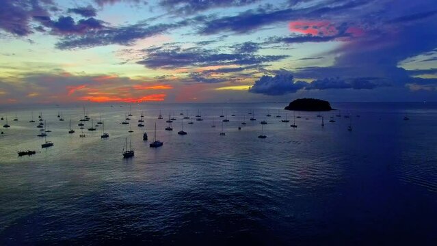 aerial view amazing sunset over the yachts. every year on the first week of December .they have yacht king cup racing in Phuket. .Kata beach is the marina of yachts. Yachts in the marina background.