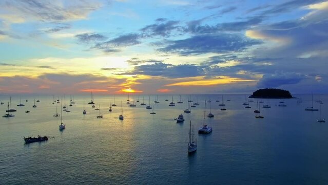 .every year on the first week of December they have yacht king cup racing in Phuket..Kata beach is the marina of yachts..Yachts in the marina background.Beautiful sunset over the yachts..