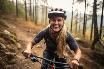 Smiling woman mountain biking in forest.