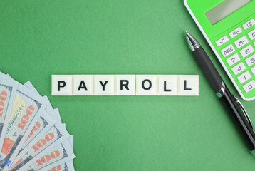 receipt, calculator, pen and letters of the alphabet with the word payroll. salary concept. salary...