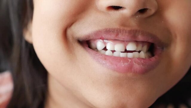 child smiling with healthy white teeth.