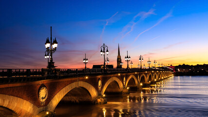 View of the Pont de pierre with sunset sky scene which The Pont de pierre crossing Garonne river.