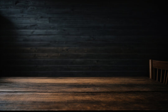 Wooden table with dark blurred background.