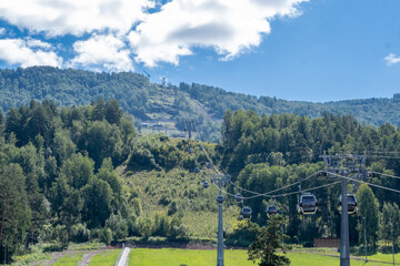 19.08.2023, Manzherok resort, Russia. Close-up of a cable car cabin against the sky. Cable car trip to viewpoints in the mountains. During the trip by cable car Tourists enjoy beautiful views 