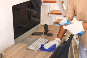 Close-up Of A Janitor's Hand Wearing Gloves Cleaning Computer