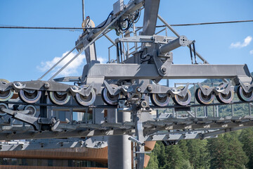 Ropeway mechanism and cable support pylon. Close-up of a cable car cabin against the sky. Cable car trip to viewpoints in the mountains. During the trip by cable car Tourists enjoy beautiful views 
