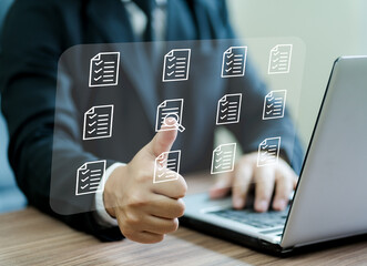 Businessman's hands checking items on documents to manage data recording system concept of document management system in the organization