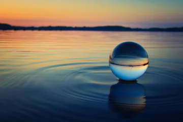 Fototapeten Lensball - Sunset over the Lake -   Landscape - Beautiful - silhouette  - Sunrise Sea - Colorful - Reed - Clouds - Sky - Sundown - Sun - Crystal Ball - Background - Water - Concept - Summer © Enrico Obergefäll