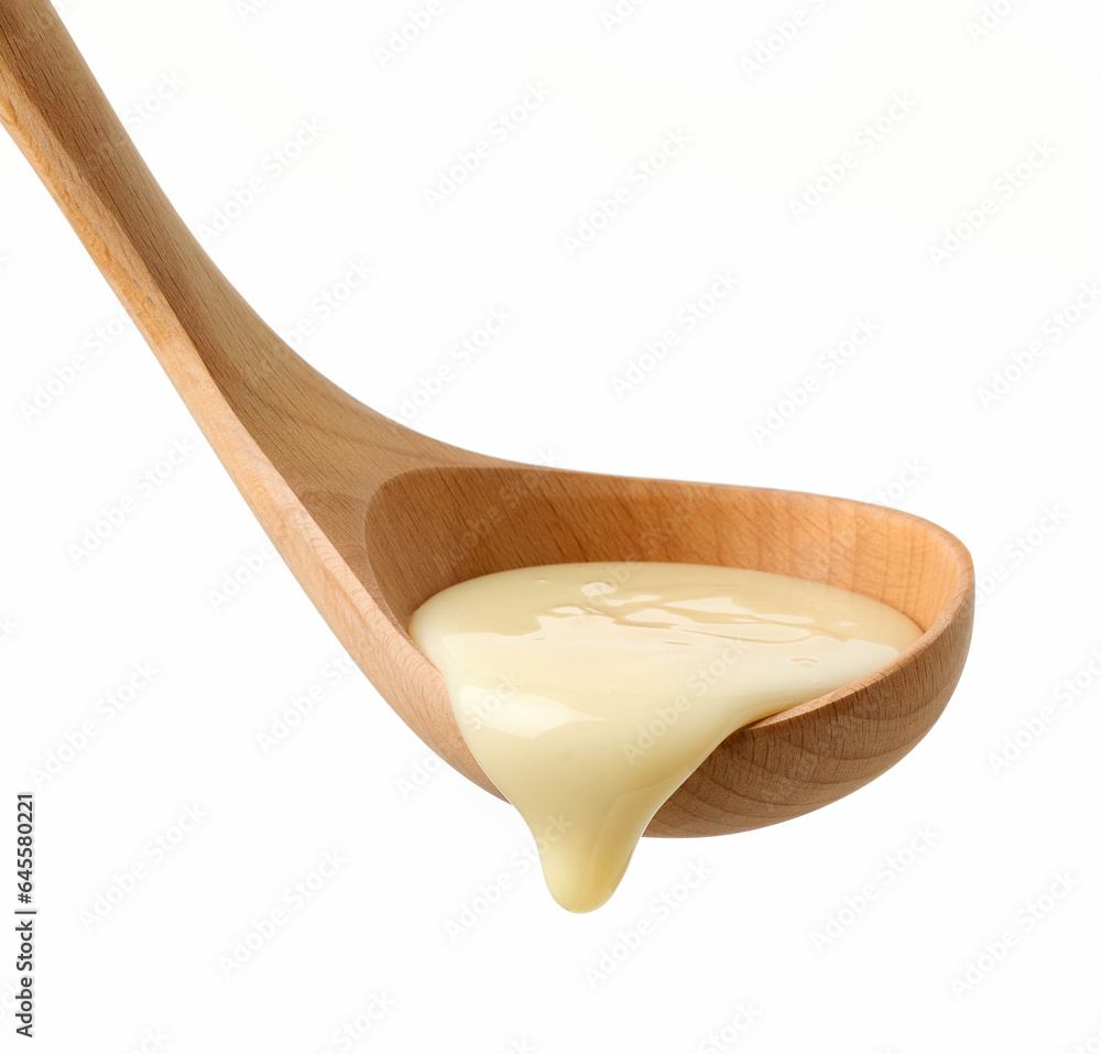 Wall mural condensed milk in wooden ladle - Wall murals