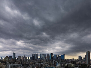 Dark clouds spread over Shinjuku's skyscrapers, photographed on 2023/08/01 12:12.
