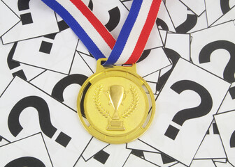 Gold medal on many question marks. Sport questions concept.