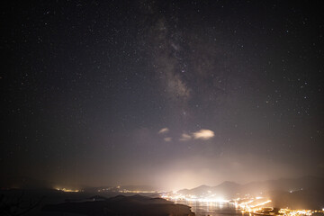 panoramic view of the sea bay with boats and ancient buildings on the island of Crete at night