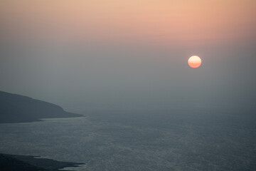 Sunset at the end of the day against the backdrop of the sea on the island of Crete