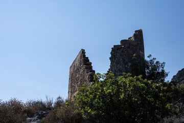 Fototapeta na wymiar Old houses and ruins and stone churches with a sunny summer day on Crete Island