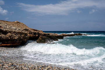Fototapeta na wymiar The turbulent sea with a sunny summer day on the island of Crete