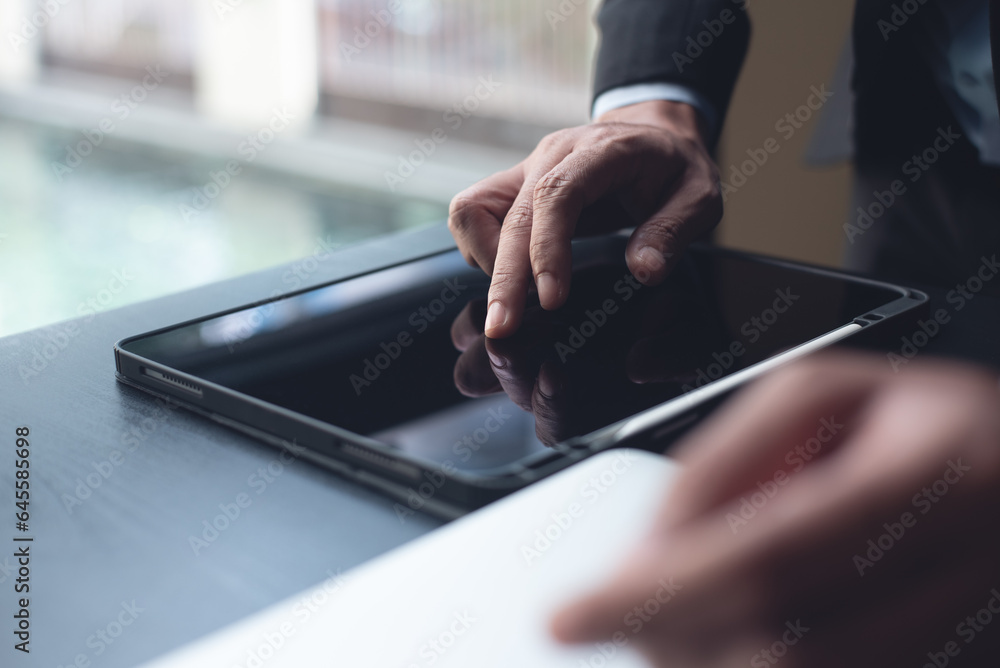 Poster businessman manager using digital tablet, finger touching on tablet screen, browsing the internet wi