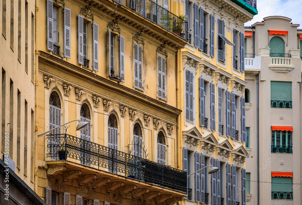 Canvas Prints ornate mediterranean house facades along a beautiful pedestrian street decorated with flowers in nic