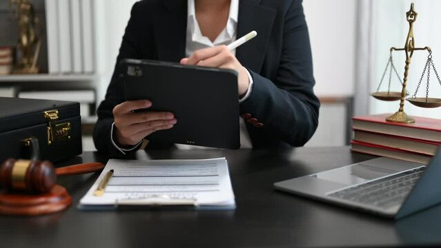 justice and law concept. Male judge in a courtroom the gavel, working with smart phone and laptop and digital tablet computer on white table ..