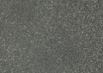 Grey rubber floor, texture, background. Dusty and worn backdrop. Faded, old, granular rubber...
