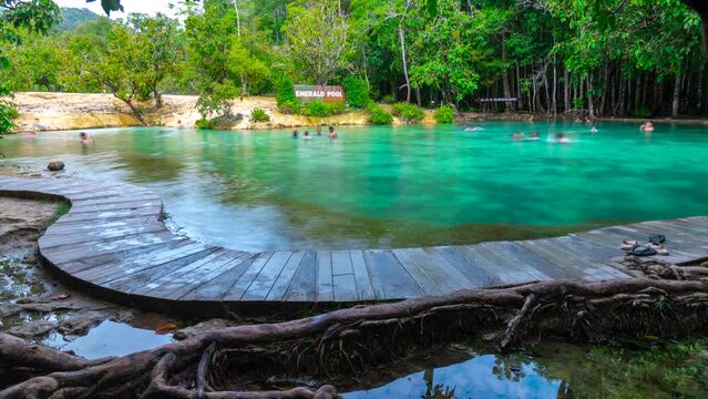 Krabi, Thailand-July 22 2023: Timelapse of tourists, visitors enjoy swimming at emerald pool in Krabi, Thailand.