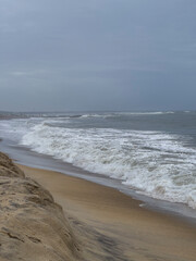 Captivating beach scene: Waves gently caressing sandy shore, a serene coastal paradise