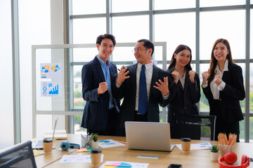 Happy Business Team of Four Professionals Celebrating Success in a Modern Office Environment, Fostering Unity and Productivity