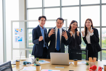 Happy Business Team of Four Professionals Celebrating Success in a Modern Office Environment, Fostering Unity and Productivity