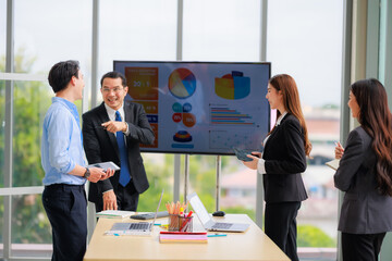 Professional Asian Colleagues in a Contemporary Office Setting, Strategizing for Corporate Growth and Efficiency