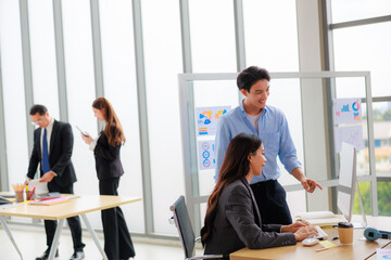Professional Asian Colleagues in a Contemporary Office Setting, Strategizing for Corporate Growth and Efficiency