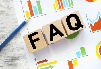 FAQ .frequently asked questions. wooden blocks on financial charts