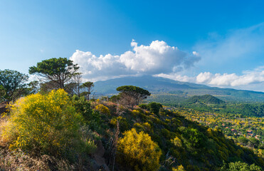 Landscape of the island of Sicily with a view of the Etna volcano in the clouds, Southern Italy.