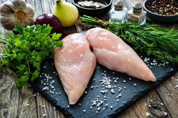 Fresh raw chicken breasts on cutting board with spices on wooden background  © Jacek Chabraszewski