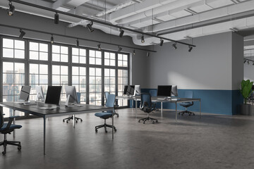 Naklejka na ściany i meble Grey office interior with pc computers and furniture, panoramic window